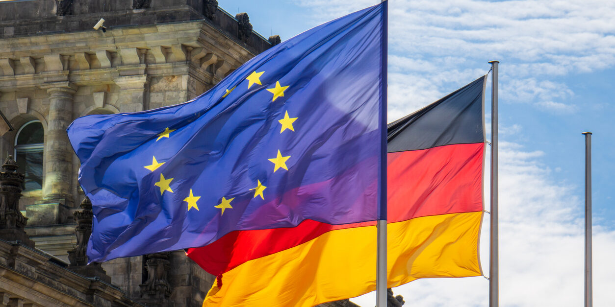 EU and German flags fly in the wind in front of the Reichstag in Berlin
