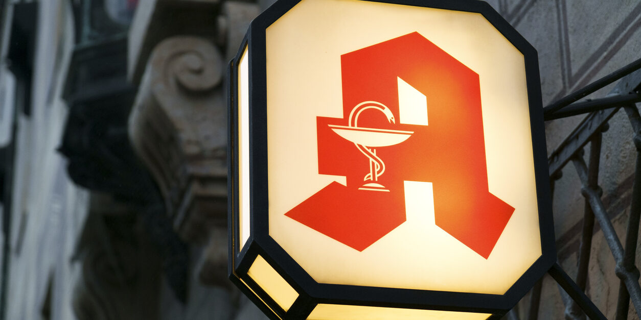 Illuminated pharmacy sign in Munich, Germany