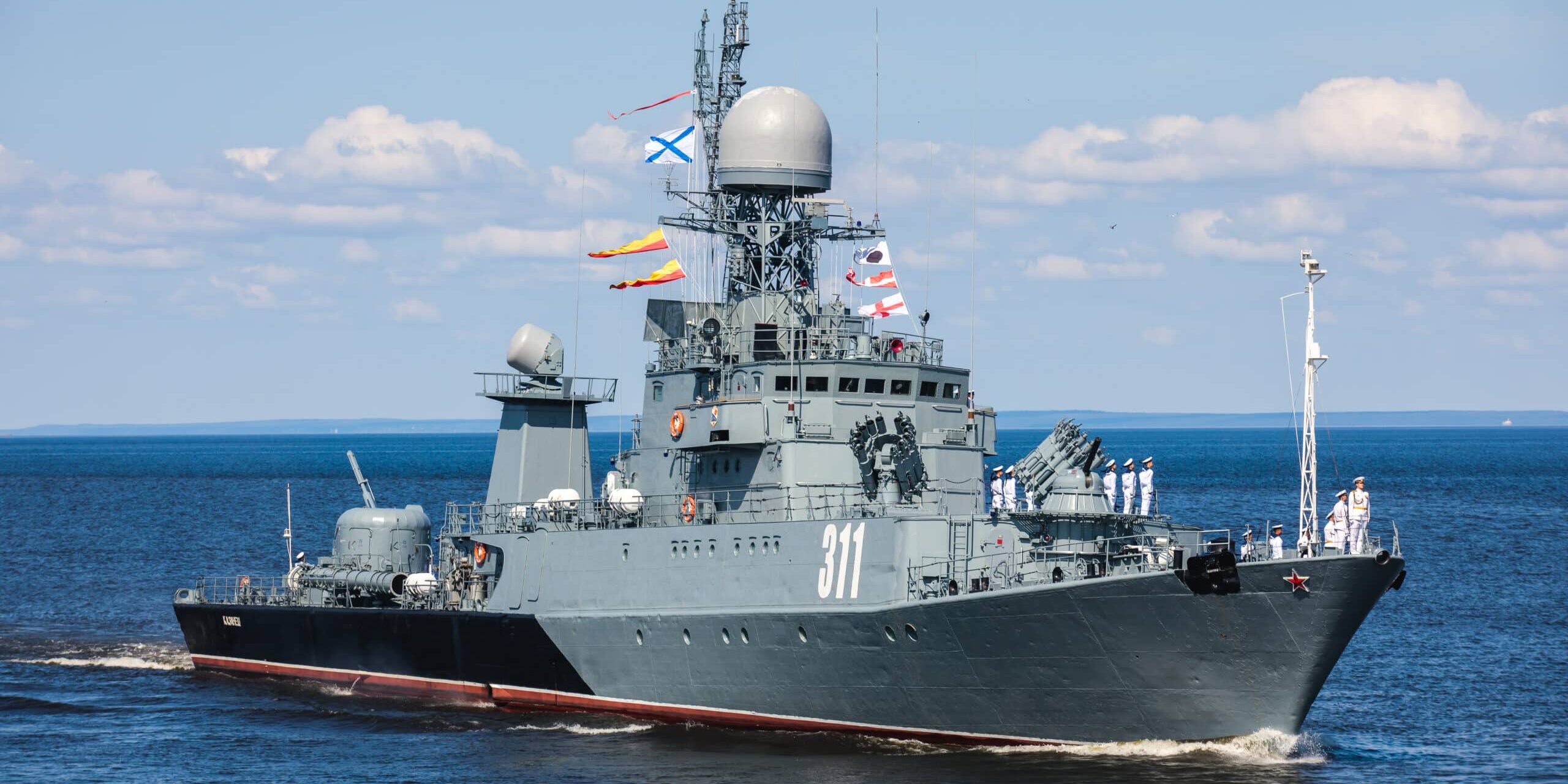 A line ahead of modern russian military naval battleships warships in the row, northern fleet and baltic sea fleet, summer sunny day